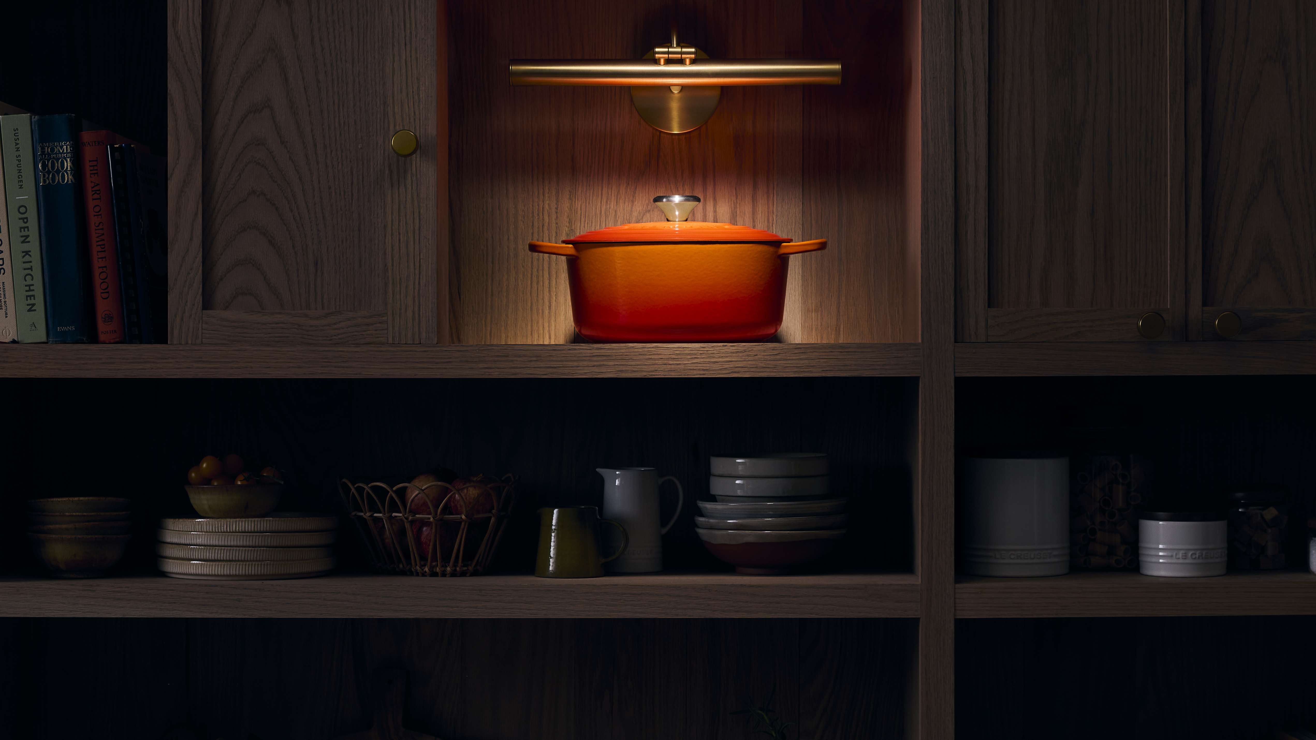 Le Creuset Cast Iron Signature Casserole in Flame on shelf 